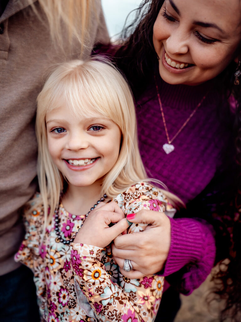 mom has hand on daughters shoulder